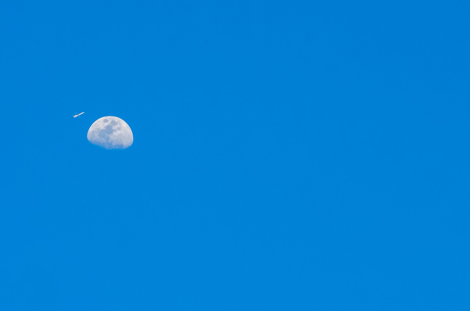 plane moon planet sky