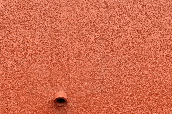 There is a wall and a pipe sticking out