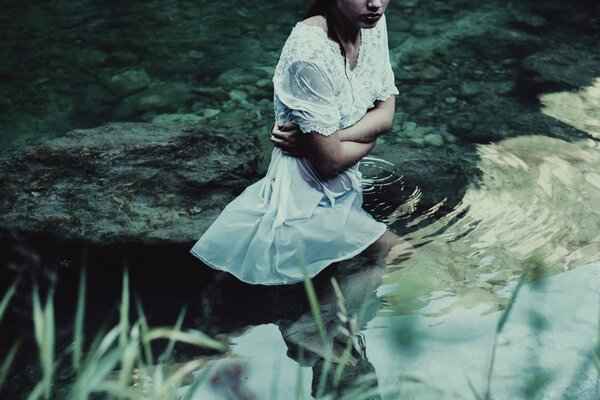 Photo shoot in quiet water, a girl in a white dress