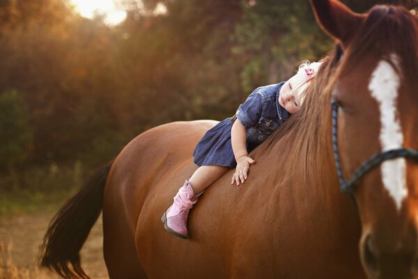 Little girl riding a horse