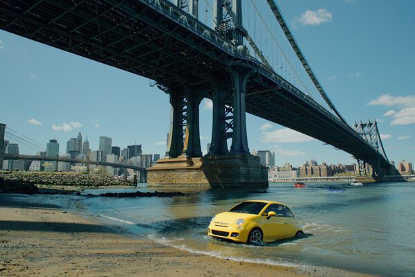 The car under the bridge comes out of the water