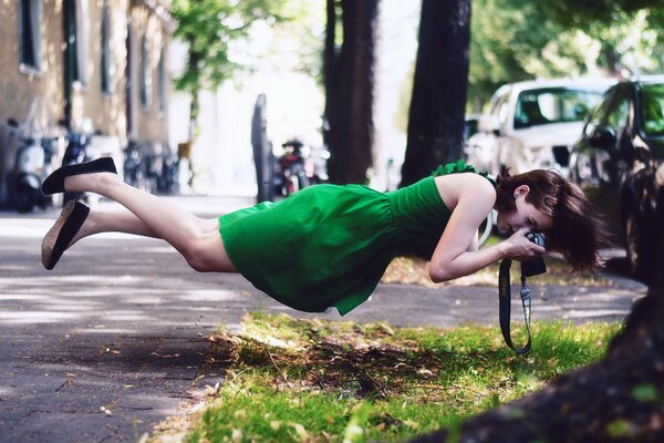 Soaring girl taking pictures of grass