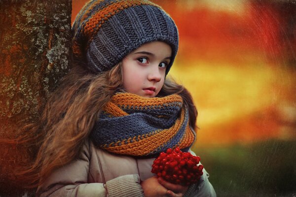 The girl picked berries and leaned against a tree