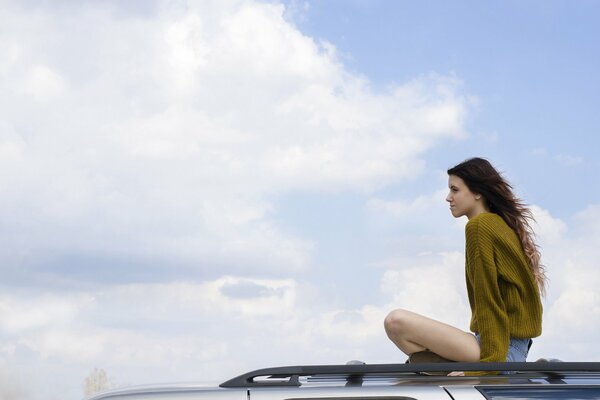 Girl on the roof of a car