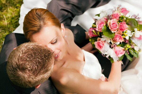 Wedding photo of the bride and groom with a bouquet