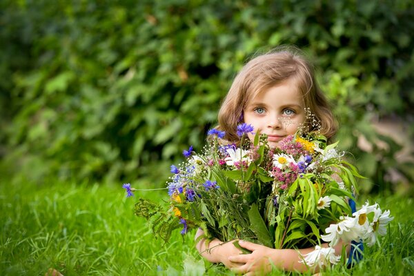 The girl collected a bouquet of wild flowers