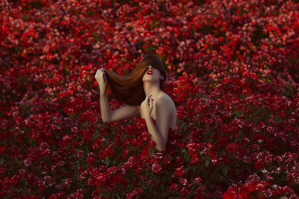 A girl with loose hair and beautiful makeup in flowers