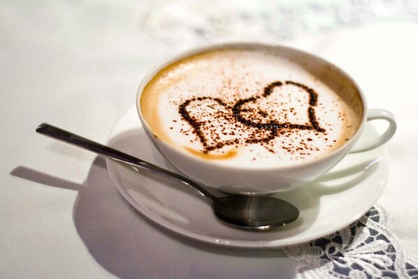 Coffee with a heart in a white cup on the table
