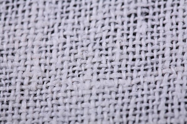 Interweaving of threads on white fabric