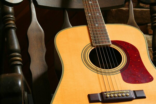 The guitar is lying on a chair