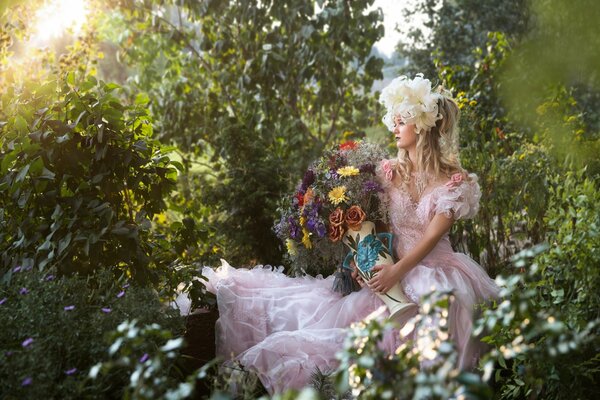 A girl is sitting in nature with flowers