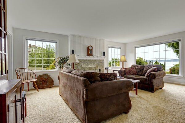 The interior of a modern living room with large windows