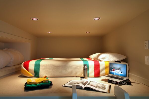 Bed. Laptop, album and thermos