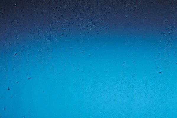 Raindrops on a blue window background
