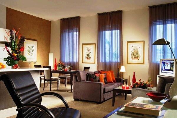 A room with orange pillows on the sofa