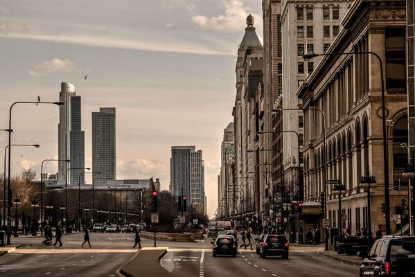 Traffic on the street among dark skyscrapers