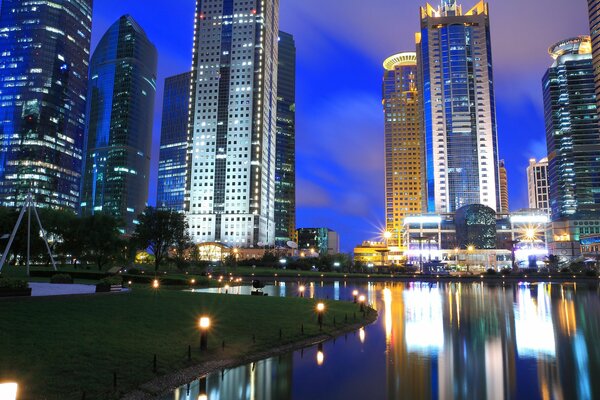 Night skyscrapers on the shore of the city lake