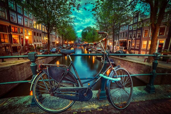 An old bicycle on a bridge in the evening Netherlands