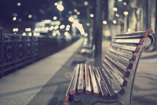 A bench on the embankment in lights