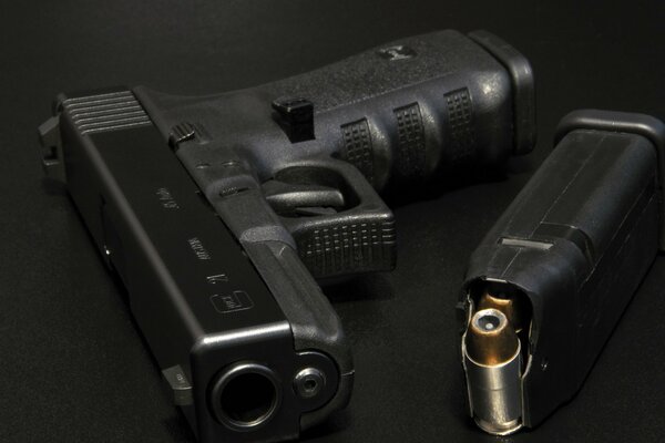 A gun with cartridges on a draft background