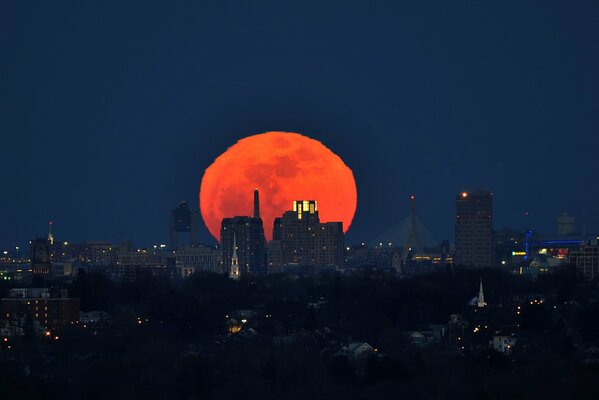 Red moon over Boston at night