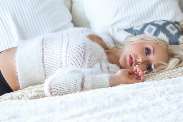 The blonde girl is lying with a sad look