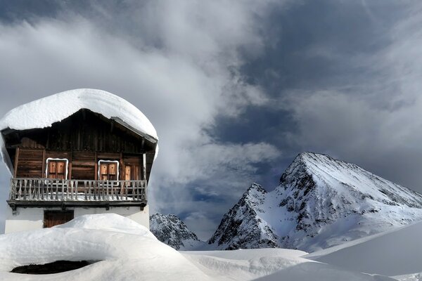 A house in the mountains. Snow. mountains