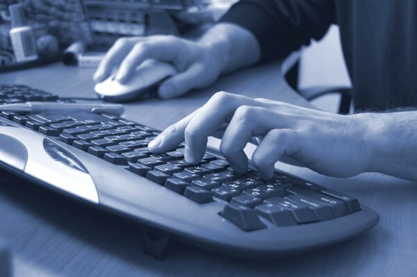 A person is typing on a computer