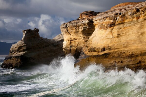 Sea surf beating against high rocks