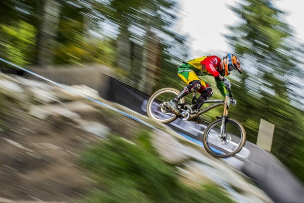 A cyclist rides on a mountain track