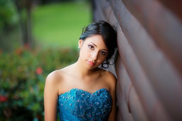 Asian girl on the background of a wooden building