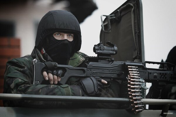 A military soldier with a weapon at the ready