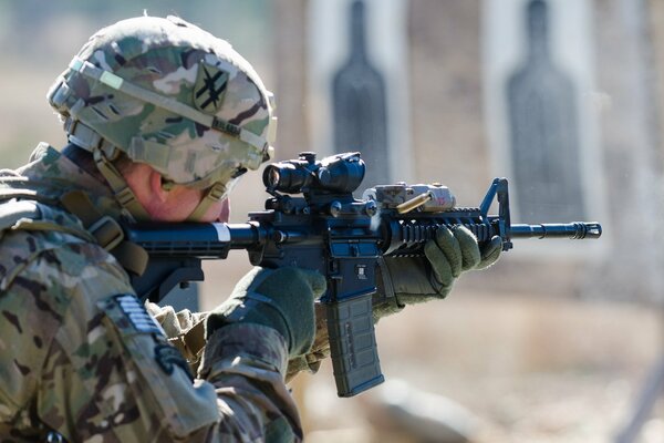 War and a soldier with a gun shoots
