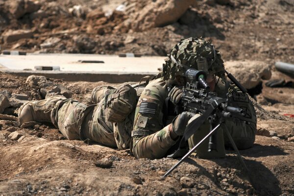 Soldier sniper aims at the target