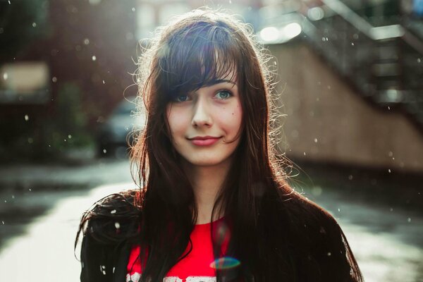 Beautiful girl standing in the rain