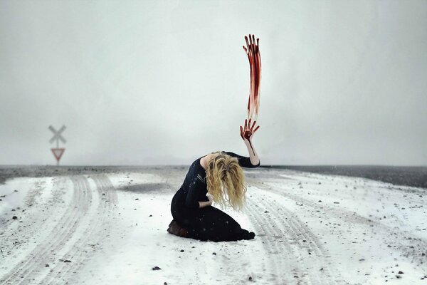 A girl in a field with a bloody hand