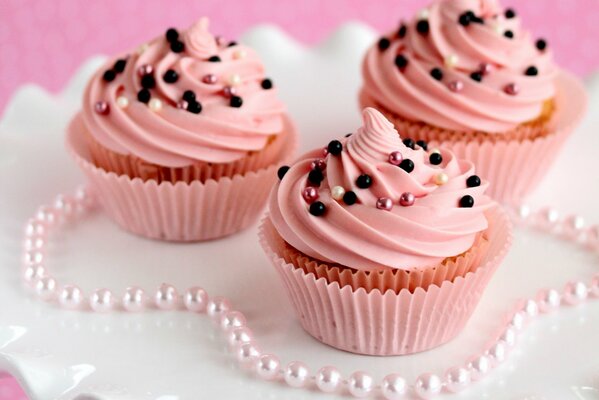 Muffins with pink cream. Sweet dessert