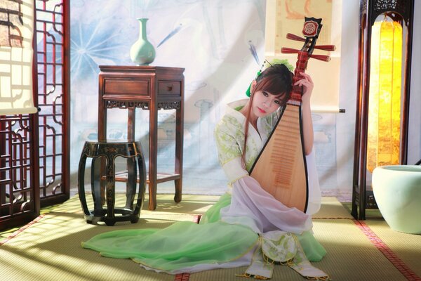 Asian girl plays music on an instrument