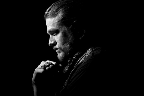 On a black background, a handsome man