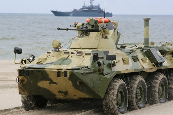 BTR-82 on the background of a warship