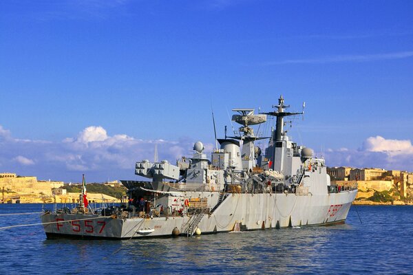 An old warship at the pier. Ship Destroyer on the water