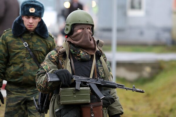 A soldier, a man stands with a machine gun