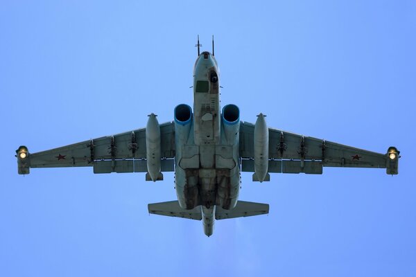 Armored subsonic attack aircraft su-25 flies in the blue sky