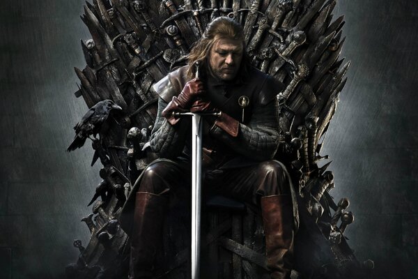A man with a sword on a black throne