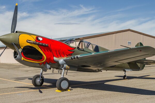 The red fighter is at the airfield