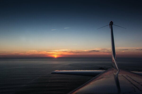 Sunset near the tail of the plane