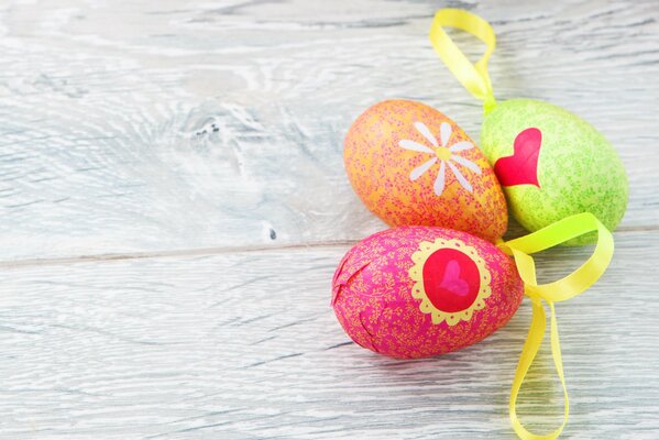 Three Easter eggs on a gray background