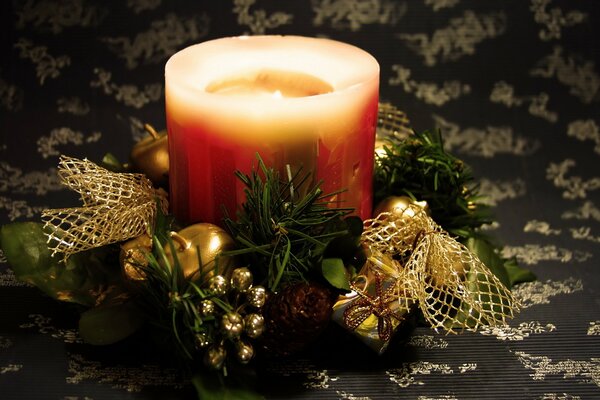 Candle with gifts on the background