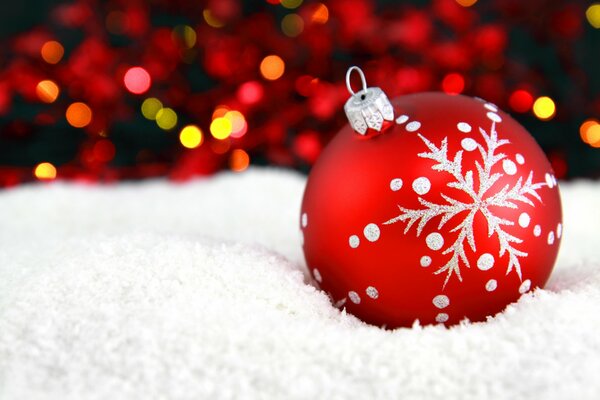 Red New Year s ball in the snow