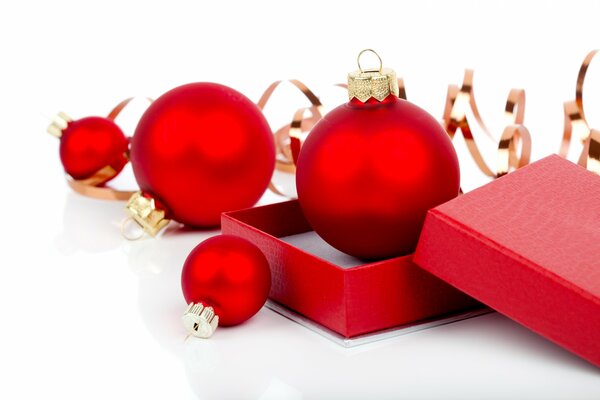 Red frosted Christmas balls in a box